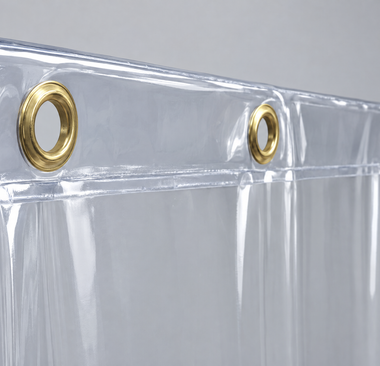 Reinforced top hem of a clear vinyl curtain with brass grommets
