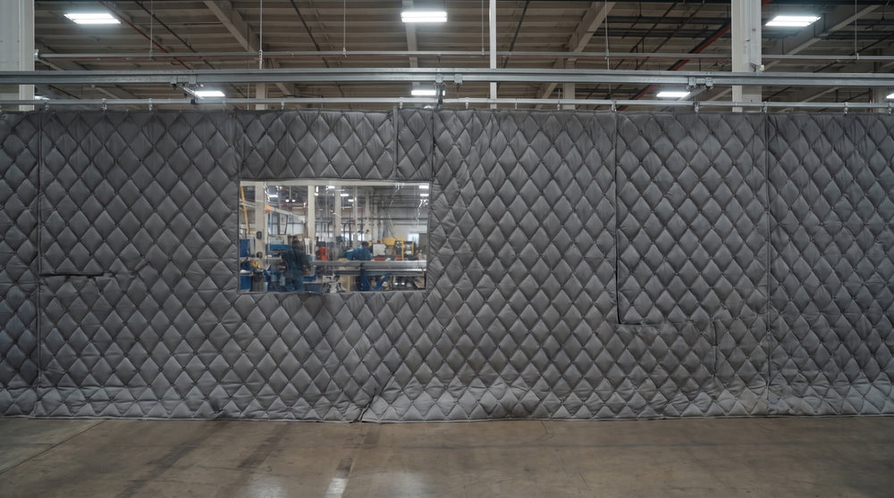 Quilted soundproof curtain wall with a clear vinyl vision window
